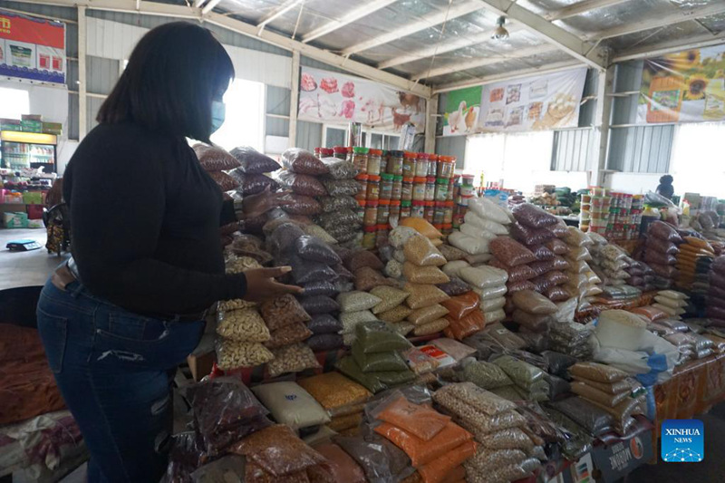 Maria Mukela, mfanyabiashara wa chakula, akionesha vyakula katika Soko la Chakula la JCS huko Lusaka, Zambia, Desemba 18, 2021. Upatikanaji wa maeneo ya biashara yenye hadhi ni changamoto kwa wafanyabiashara wengi wadogo wa bidhaa za chakula nchini Zambia. Ni kwa sababu hii Kampuni ya Jihai Central Sports (JCS), inayomilikiwa na Wachina ambayo inafanya biashara nchini Zambia, iliamua kuwawezesha wafanyabiashara wadogo wa bidhaa za chakula mjini Lusaka kwa kuwapa maeneo safi na ya bei nafuu ya biashara. (Picha na Lillian Banda/Xinhua)