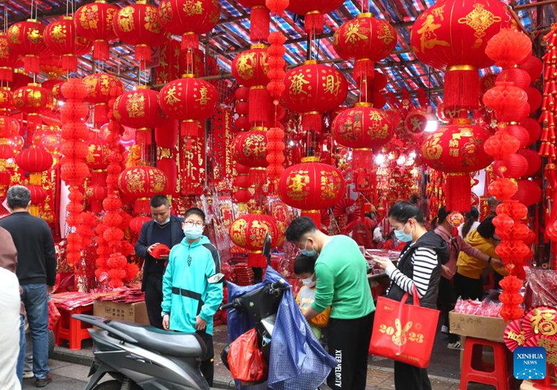 Wakazi wakichagua mapambo kwa ajili ya sherehe zijazo za Mwaka Mpya wa Jadi wa China kwenye maonyesho ya bidhaa Katika Mtaa wa Shanghai wa Mji wa Nanning, Mkoa unaojiendesha wa Guangxi nchini China, Januari 14, 2023. (Xinhua/Zhou Hua)