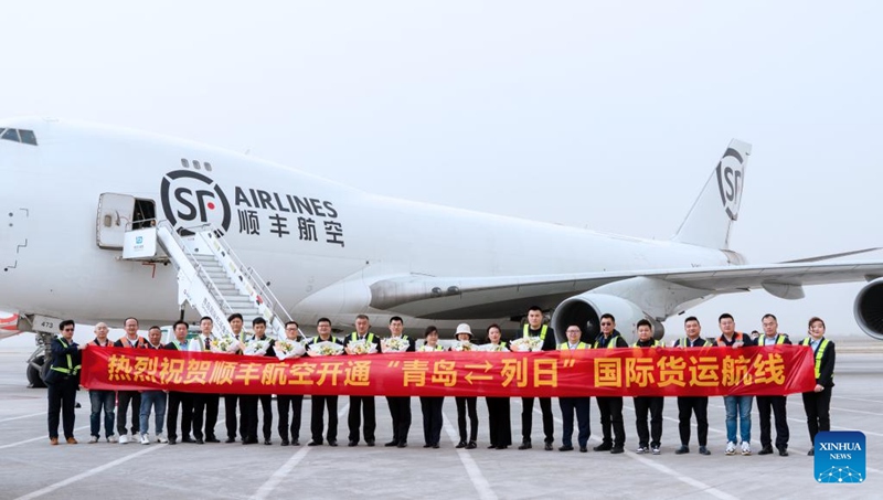 Wafanyakazi wakiwa katika picha ya pamoja mbele ya ndege ya mizigo ya Shirika la Ndege la SF kusherehekea uanzishwaji wa njia ya  usafiri wa ndege za mizigo inayounganisha Mji wa Qingdao nchini China na Mji wa Liege nchini Ubelgiji, kwenye Uwanja wa Ndege wa Kimataifa wa Qingdao Jiaodong  mkoani Shandong, Mashariki mwa China, Aprili 11, 2023. (Shirika la Ndege la SF/ Xinhua)