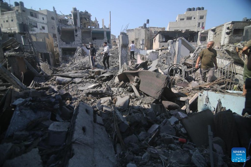 Watu wakikagua majengo yaliyobomolewa kwenye mashambulizi ya anga ya Israel katika mji wa Kusini mwa Ukanda wa Gaza wa Rafah, Oktoba 11, 2023. (Khaled Omar/Xinhua)