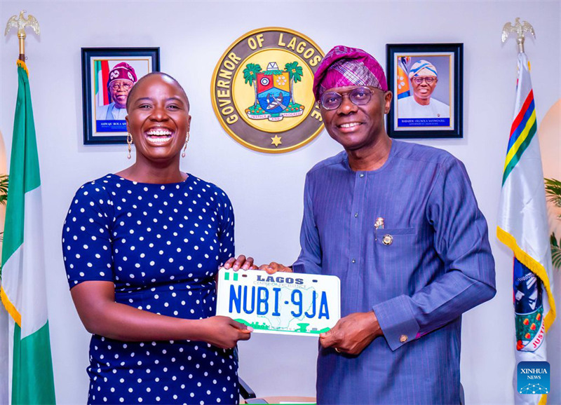 Gavana wa Babajide Sanwo-Olu wa Jimbo la Lagos (Kulia) akimkabidhi Namba ya Mahsusi ya Gari Pelumi Nubi kwenye mkutano kati ya Gavana na Nubi katika ofisi ya gavana ya Lagos, Marina, Nigeria, Aprili 8, 2024. (Shirika la Habari la Nigeria/ Xinhua)