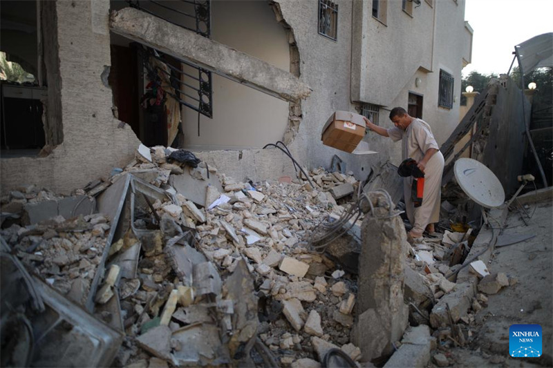 Mtu akikusanya vitu kutoka kwenye kifusi baada ya shambulizi la Israeli katika kambi ya wakimbizi ya al-Nuseirat, katikati mwa Ukanda wa Gaza, Oktoba 28, 2024. (Picha na Marwan Dawood/Xinhua)