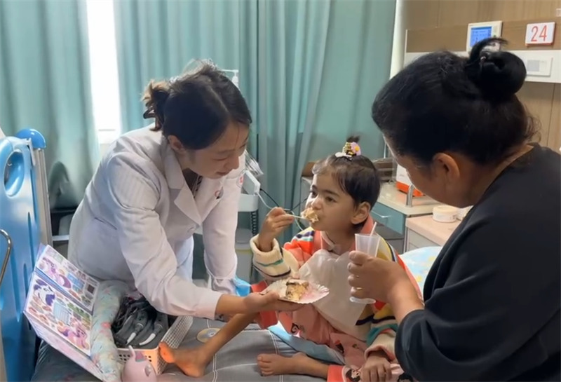 Xiao Yiyi akila keki ya siku ya kuzaliwa. (Picha imetolewa na Hospitali ya Watoto ya Chuo Kikuu cha Zhejiang)