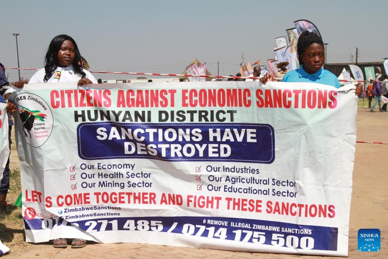 Vijana wa Zimbabwe wakishika bango la kupinga vikwazo vya nchi za Magharibi mjini Harare, Zimbabwe, Oktoba 25, 2025. (Xinhua/Tafara Mugwara)