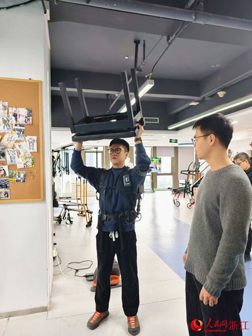 Mtu akijaribu roboti ya exoskeleton ya kusaidia kubeba mizigo viwandani kwenye shughuli ya manunuzi katika Uwanja wa Wushan mjini Hangzhou, Mkoa wa Zhejiang, mashariki mwa China. (People's Daily Online/Kang Mengqi)