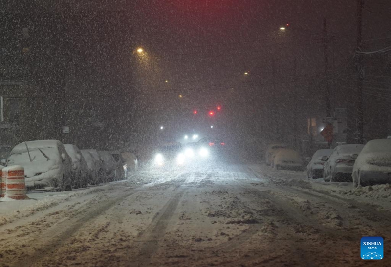 Magari yakiendeshwa kwenye theluji barabarani jijini New York, Marekani, Februari 22, 2026. (Xinhua/Zhang Fengguo)