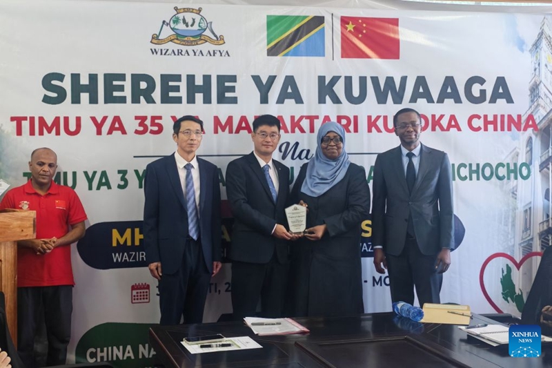 Picha hii iliyopigwa kwa simu ya mkononi ikimwonesha Kaimu Waziri wa Afya wa Zanzibar Saada Mkuya Salum (wa pili, kulia) akikabidhi cheti cha heshima kwa kundi la tatu la wataalamu chini ya awamu ya pili ya mradi wa kuzuia na kudhibiti kichocho unaosaidiwa na China, visiwani Zanzibar, Tanzania, Agosti 31, 2026. (Timu ya Wataalamu wa Mradi wa Kuzuia na Kudhibiti Kichocho unaosaidiwa na China/kupitia Xinhua)
